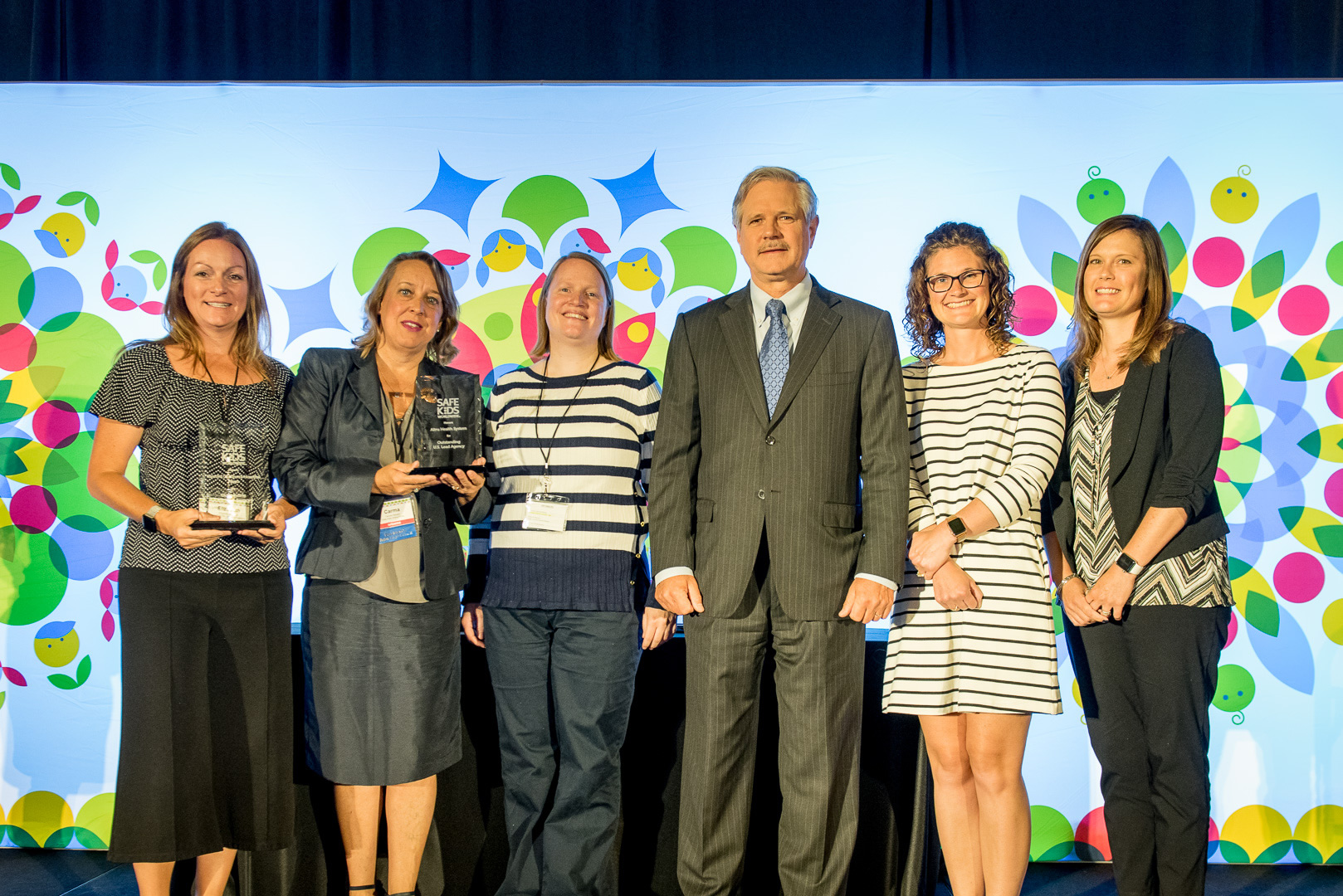 Safe Kids Grand Forks staff receiving 2019 Outstanding Lead Agency Award